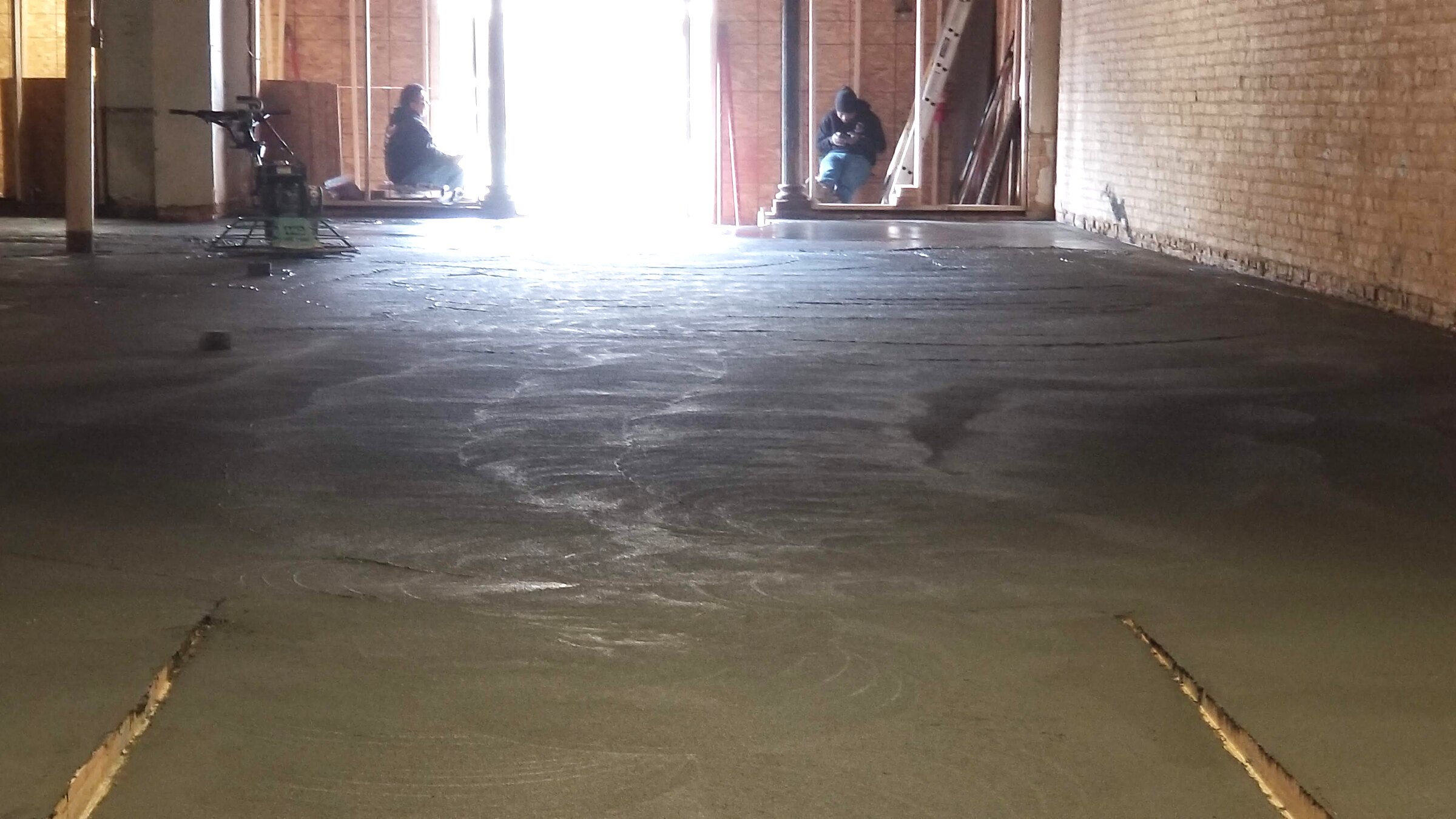 Crew finishing the new interior concrete floor